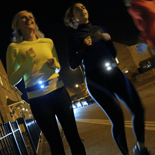 Runners jogging across road with Million Mile Lights