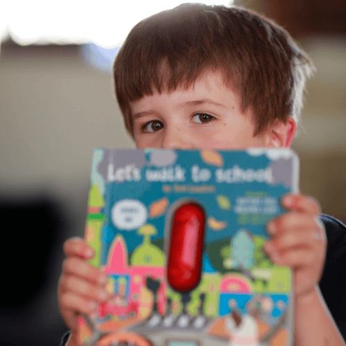 Boy holding Million Mile Light Kids Book